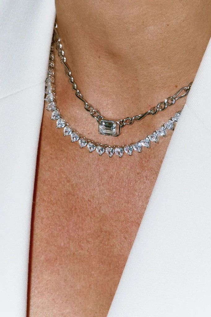 woman wearing diamond necklaces